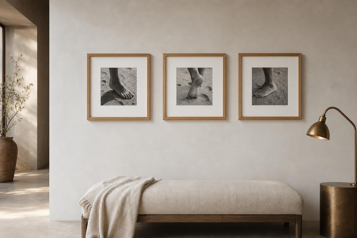 Three 10×10 inch oak-framed photographs hung in a row above a linen bench